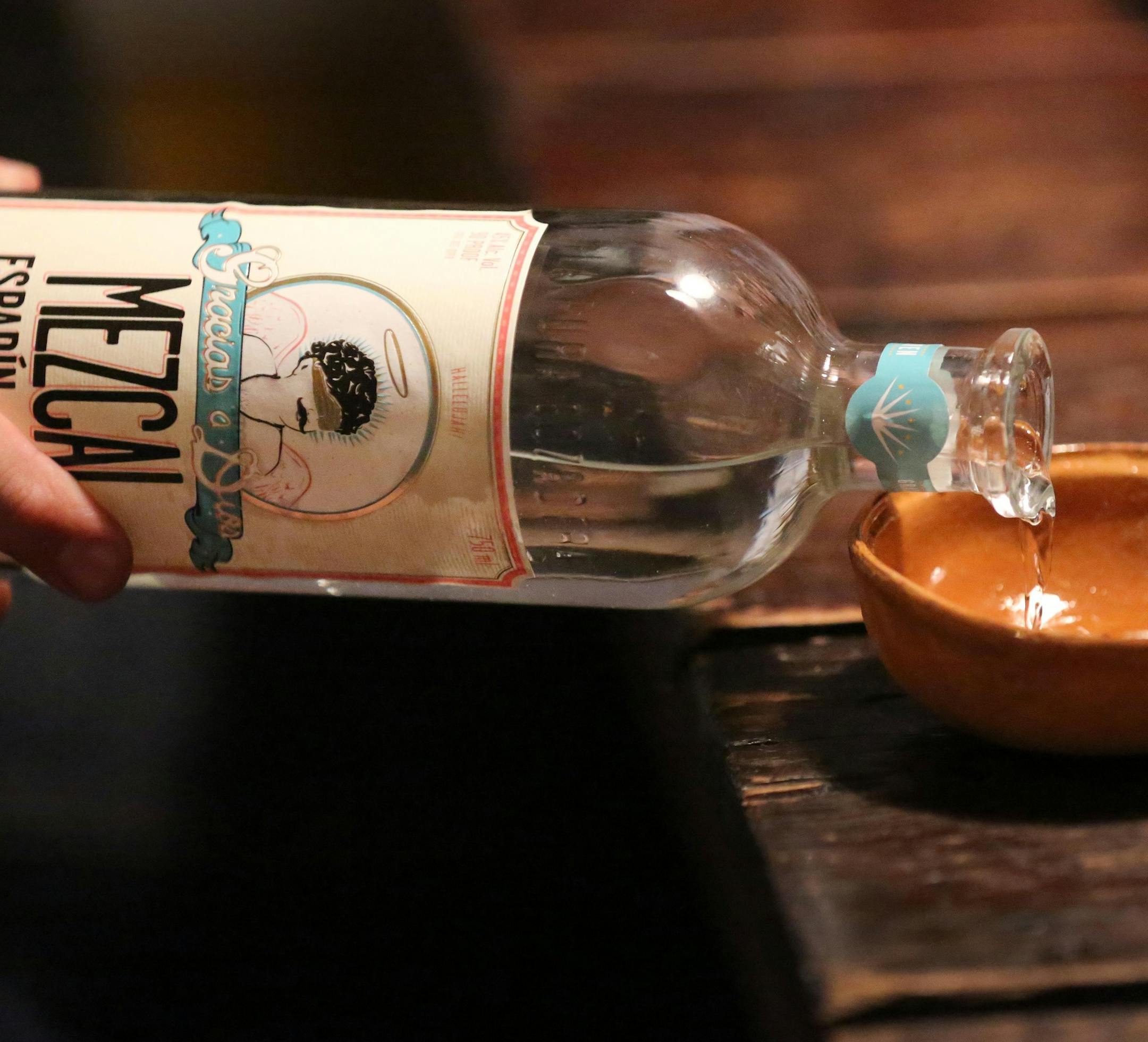 ADVANCE FOR WEEKEND EDITIONS, DEC. 12-13 - In this photo taken Dec. 1, 2015, Mezcal is poured into small ceramic bowls for tasting during a tasting party at Shad Kvetko's home in Dallas (Louis DeLuca/The Dallas Morning News via AP) MANDATORY CREDIT; MAGS OUT; TV OUT; INTERNET USE BY AP MEMBERS ONLY; NO SALES
