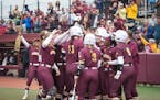 The Gophers celebrated one of two home runs from Taylor Krapf (13) in Saturday’s victory against Michigan at Jane Sage Cowles Stadium.