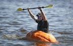 Adam Ostlund, a server at Smalley's Caribbean Barbeque in Stillwater, rejoiced after crossing the finish line to win the Pumpkin Regatta at the Stillw