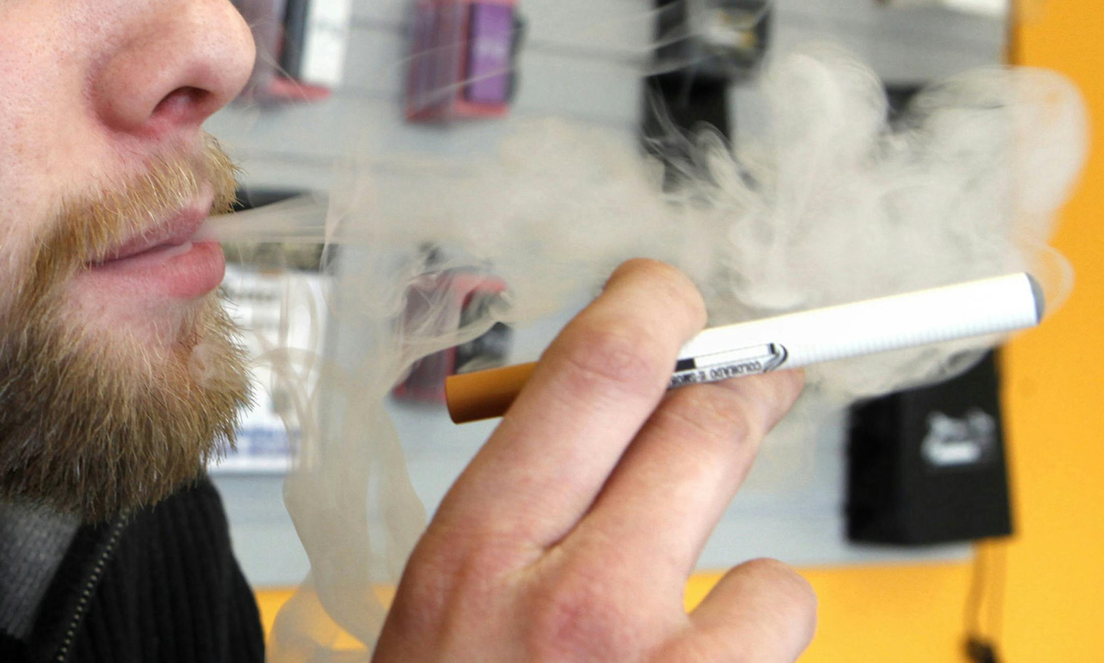 FILE - A sales associate demonstrates the use of a electronic cigarette and the smoke like vapor that comes from it in Aurora, Colo. on Wednesday, March 2, 2011. Children - like adults - are increasingly trying electronic cigarettes, according to the first large national study to gauge use by middle and high school students. About 2 percent of the students said theyíd used an e-cigarette in the previous month, according to a survey done in 2012. That was up from 1 percent in 2011. Results w