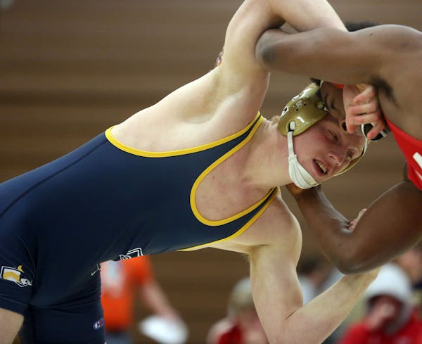 Lance Benick, of Totino-Grace, went up in weight class to wrestle Benilde St. Margaret's Christian DuLaney during a wrestling meet in Fridley Thursday
