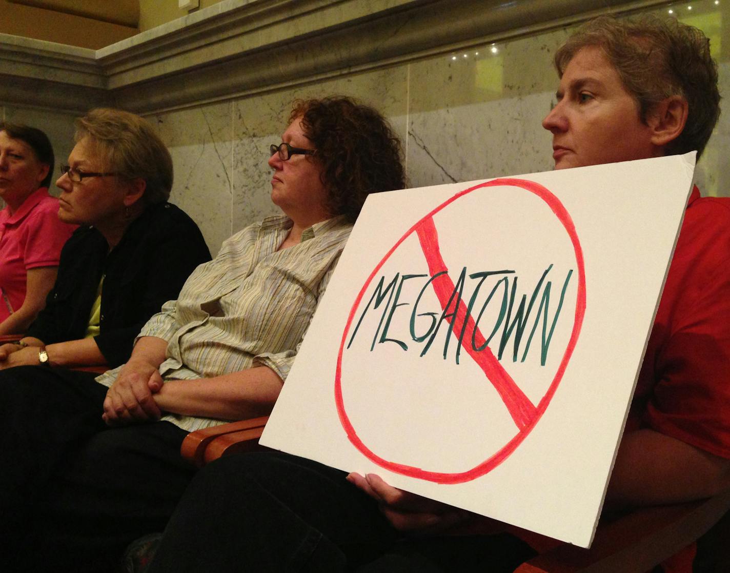 Jennifer Syverson sits with other opponents of Opus' six-story Dinkytown development at a City Council committee meeting on Thursday morning. ] ERIC ROPER/STAR TRIBUNE