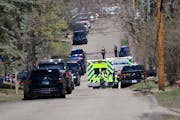 Law enforcement vehicles line the streets near Mayview Road and North St. in Minnetonka on Wednesday.