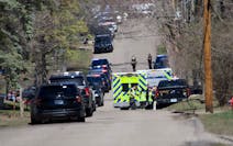 Law enforcement lines the streets near Mayview Road and North St. in Minnetonka on Wednesday.