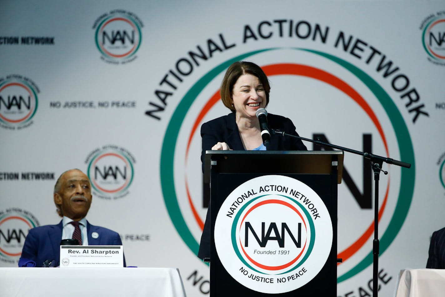 Democratic presidential candidate Sen. Amy Klobuchar, D-Minn speaks at the National Action Network South Carolina Ministers' Breakfast, Wednesday, Feb. 26, 2020, in North Charleston, S.C., as the Rev. Al Sharpton looks on.