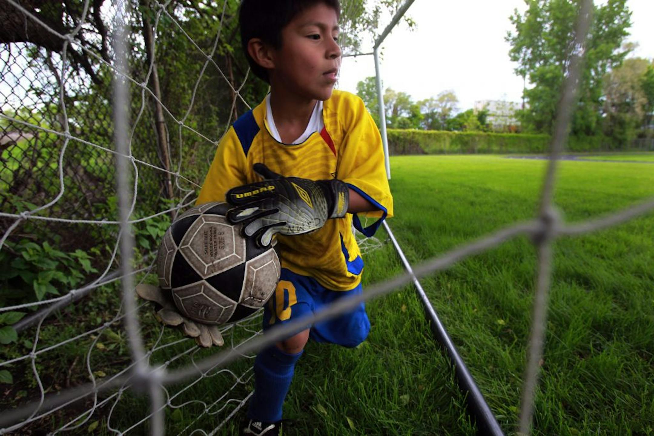 Christian Riera, 7, nabbed a ball shot by one of his brothers as their father played soccer on an adjacent field at Edison High School in northeast Minneapolis.