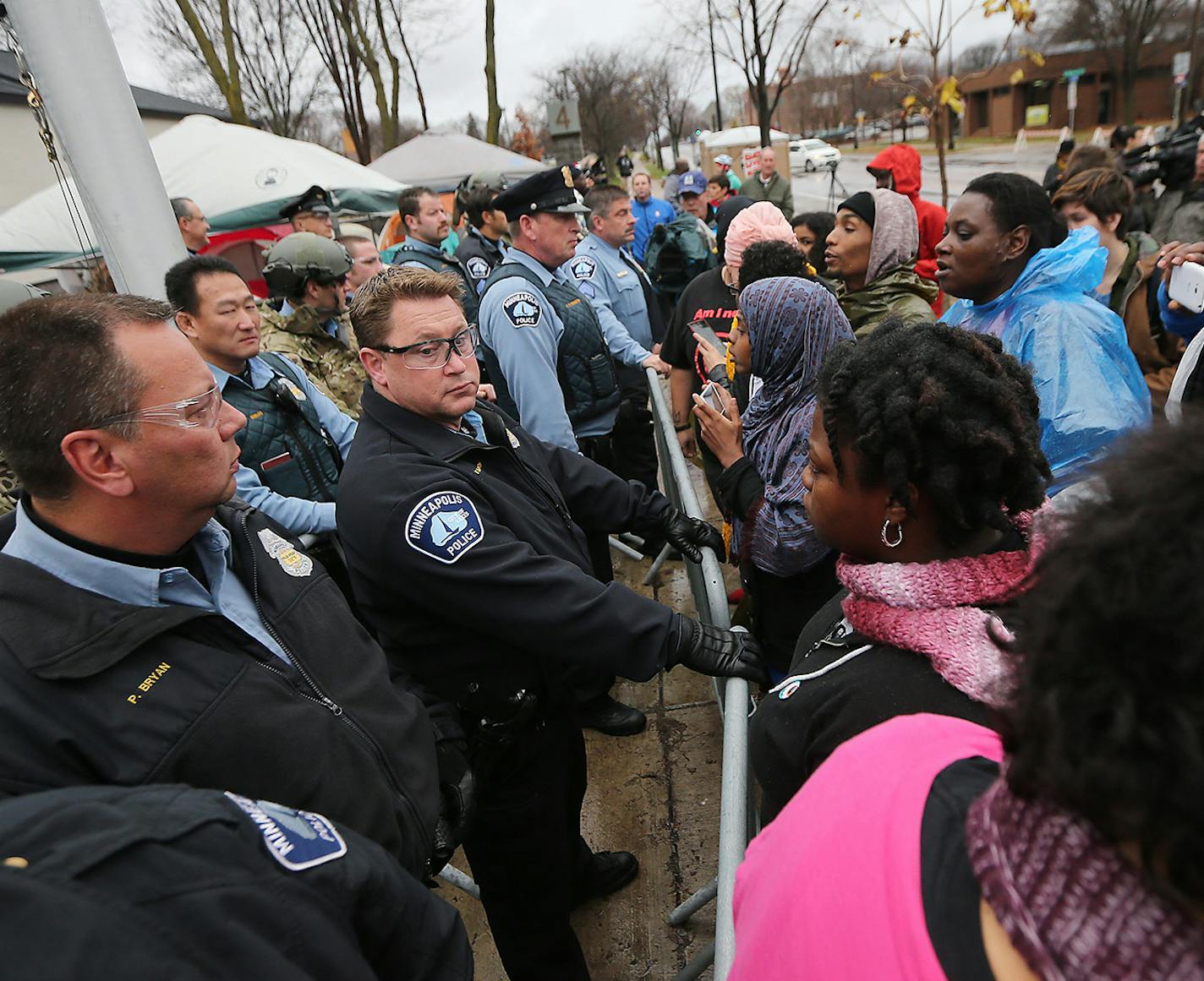 Protestors yelled profanities, flipped them off, and spit on them during a protest over the death of Jamar Clark, at the Fourth Police Precinct, Wednesday, November 4, 2015 in Minneapolis, MN. ] (ELIZABETH FLORES/STAR TRIBUNE) ELIZABETH FLORES &#x2022; eflores@startribune.com