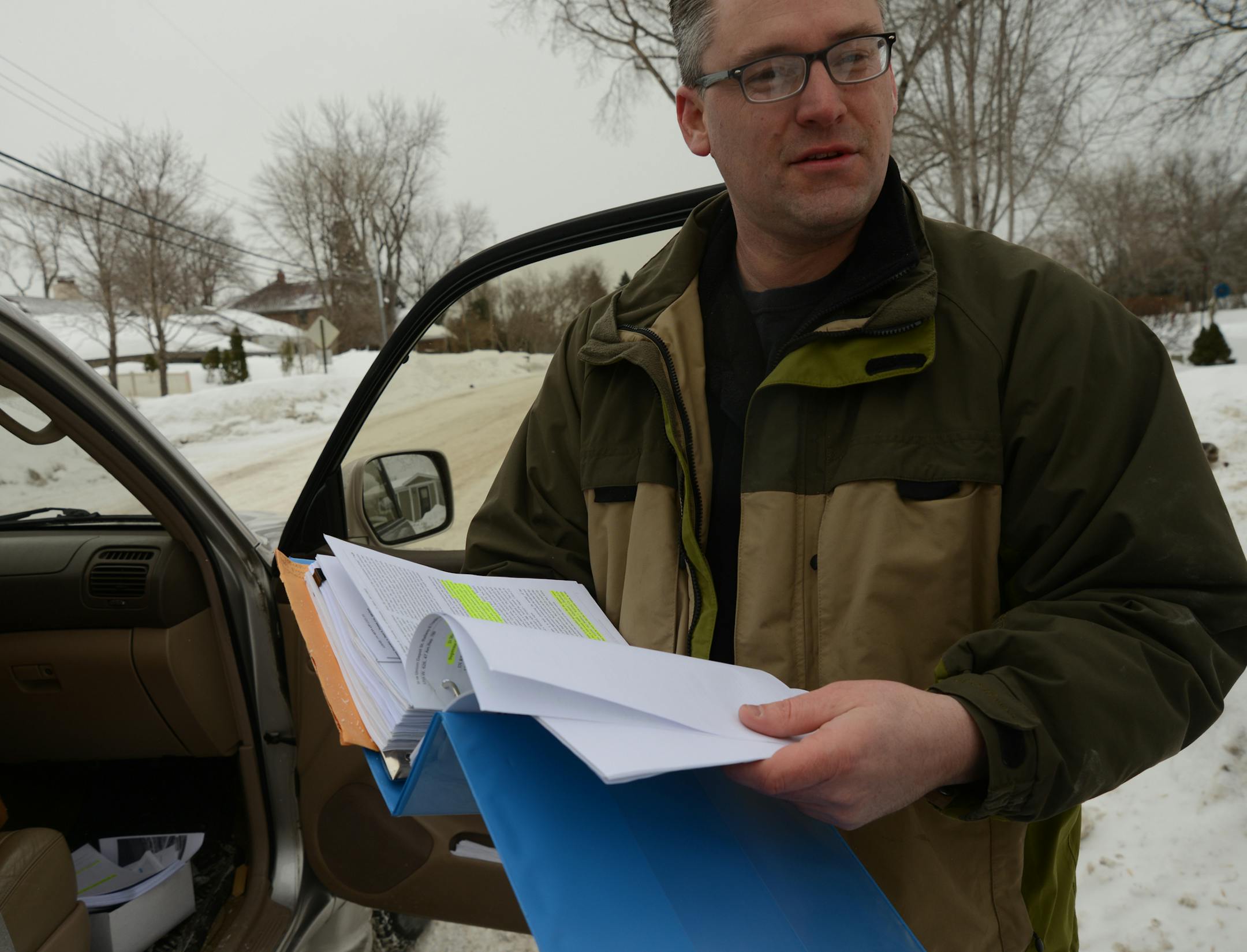 Dan Gustafson bought a 5-foot strip out of land between two lake homes on the shoreline of Plymouth's Medicine Lake, he held a a thick binder of all the info on his land in question .] Dan Gustafson bought a 5-foot strip of land wedged between two lake homes on the shoreline of Plymouth's Medicine Lake so he could boat and access the lake. But he's finding out that it's not that easy. The city says that, without a house on the narrow sliver of land, zoning rules restrict the Minnetonka man from