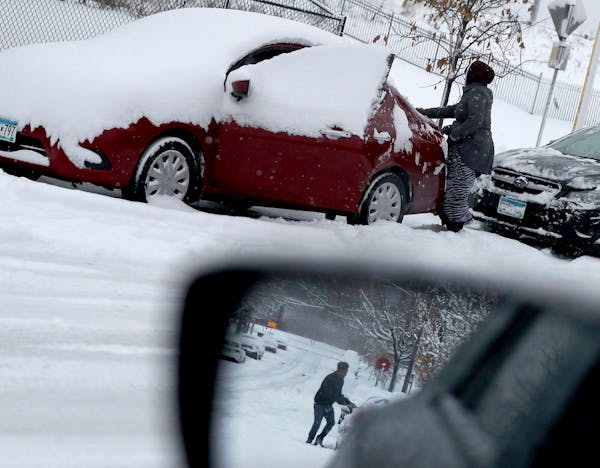 Residents cleared their cars of snow in the Cedar-Riverside neighborhood of Minneapolis.