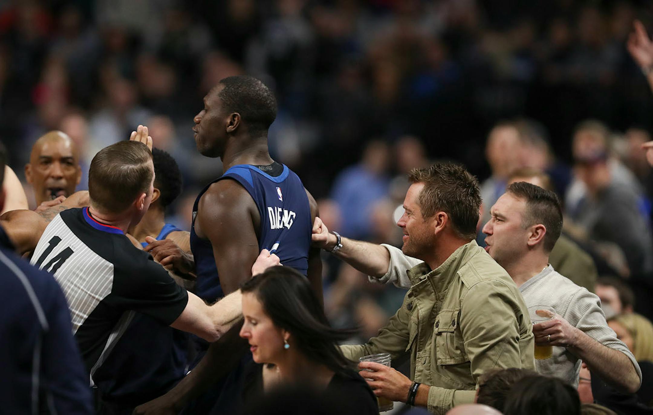 Minnesota Timberwolves center Gorgui Dieng (5) was helped back up - or punched - by fans sitting courtside after he was shoved into the seats by Houston Rockets guard Gerald Green in the fourth quarter.