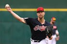 FILE - In this March 11, 2019, file photo, Cleveland Indians starting pitcher Corey Kluber throws a warm up pitch before a spring training baseball ga