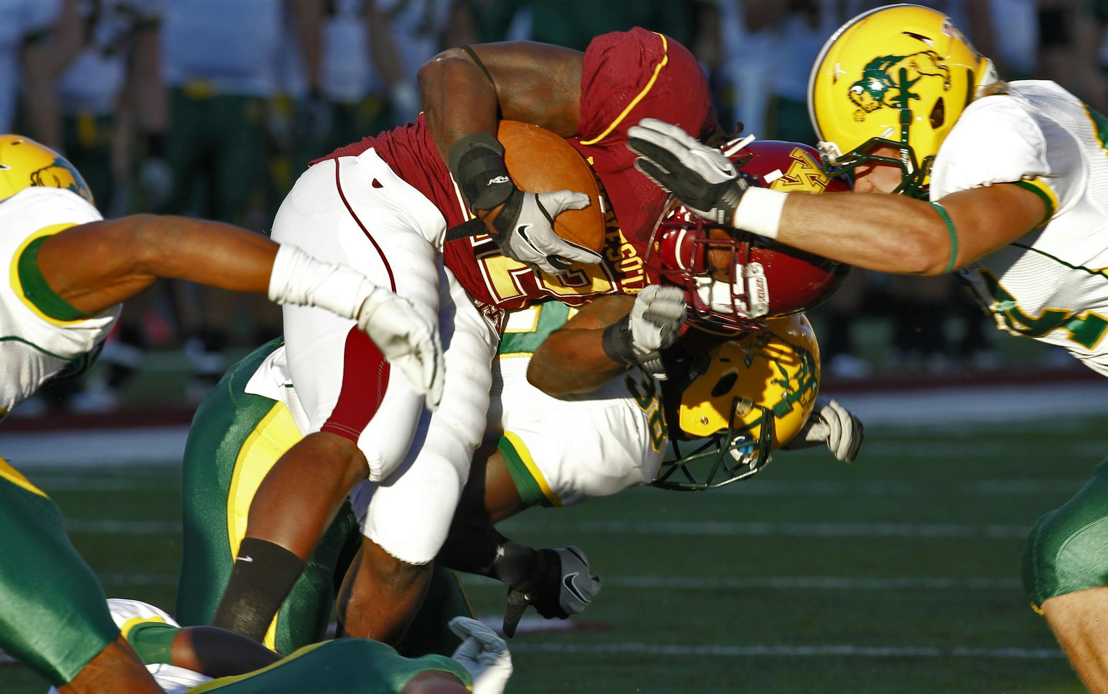 Gophers running back Duane Bennett was thrown for a loss by the Bison in first-half action.
