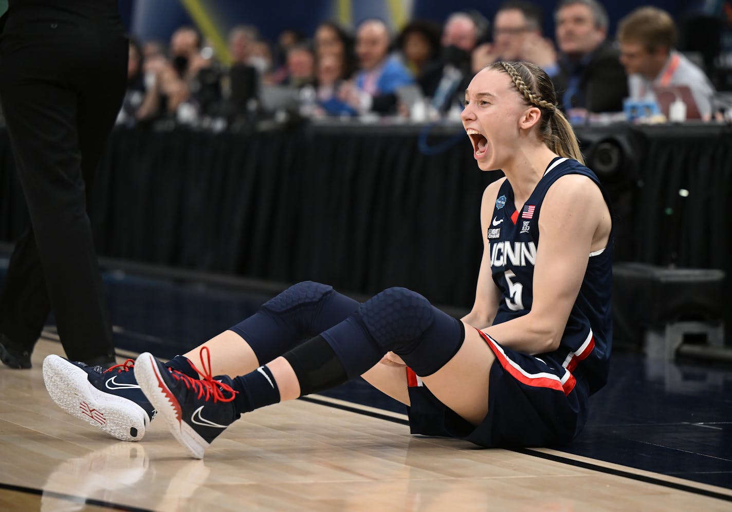 UConn's Paige Bueckers reacts after taking a charge during Friday's semifinal game vs. Stanford at Target Center.