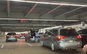 Cars are backed up at the pickup area on the baggage-claim level at Minneapolis-St. Paul International Airport.