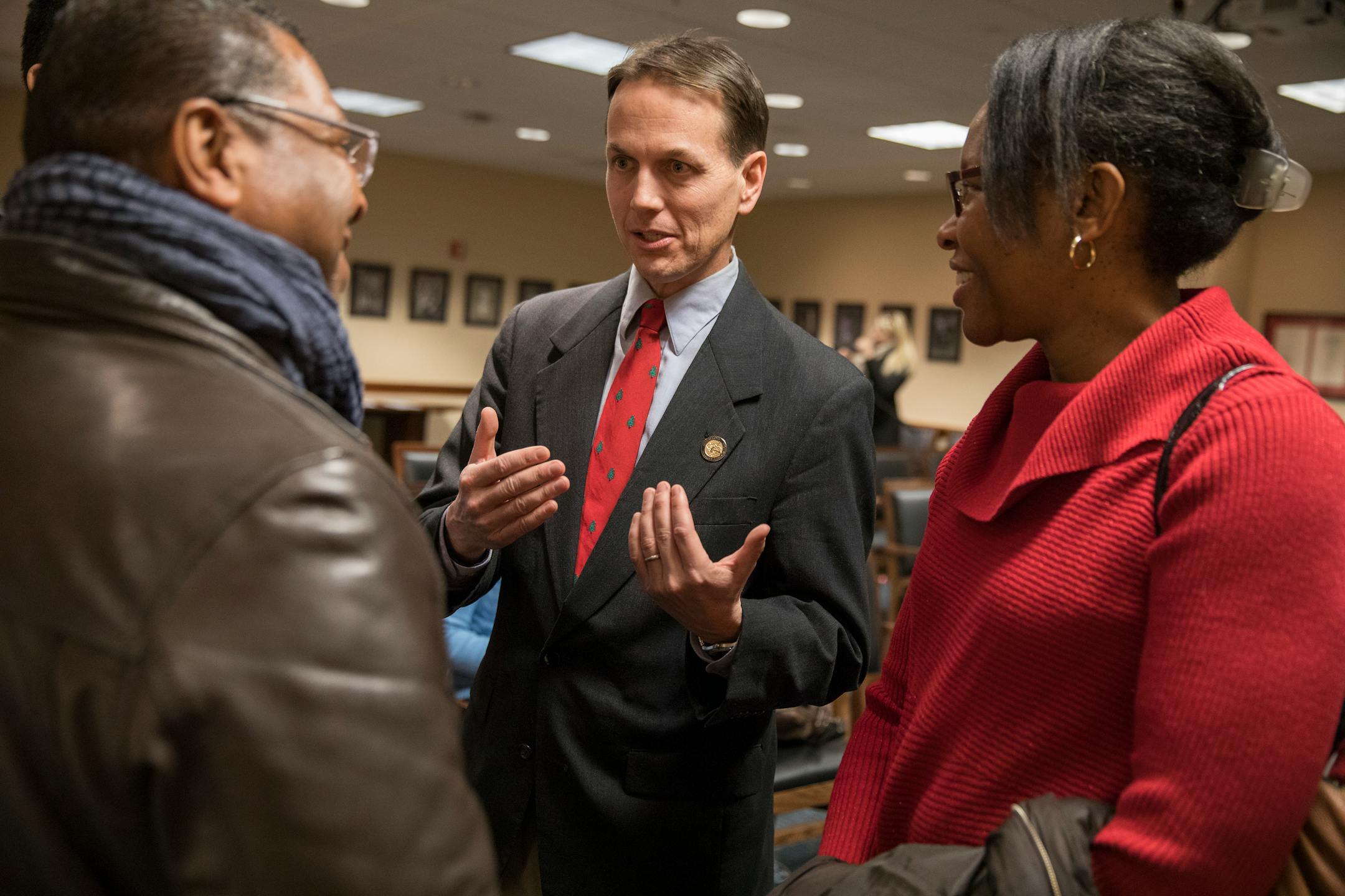 Falcon Heights Mayor Peter Lindstrom, center, spoke with Pastor Brian Herron of Zion Baptist Church in Minneapolis, left, and Melanie Leehy, right, the co-chair of the Falcon Heights Task Force on Policing talk after a news conference in December announcing the launch of a collaborative review of the St. Anthony Police Department.