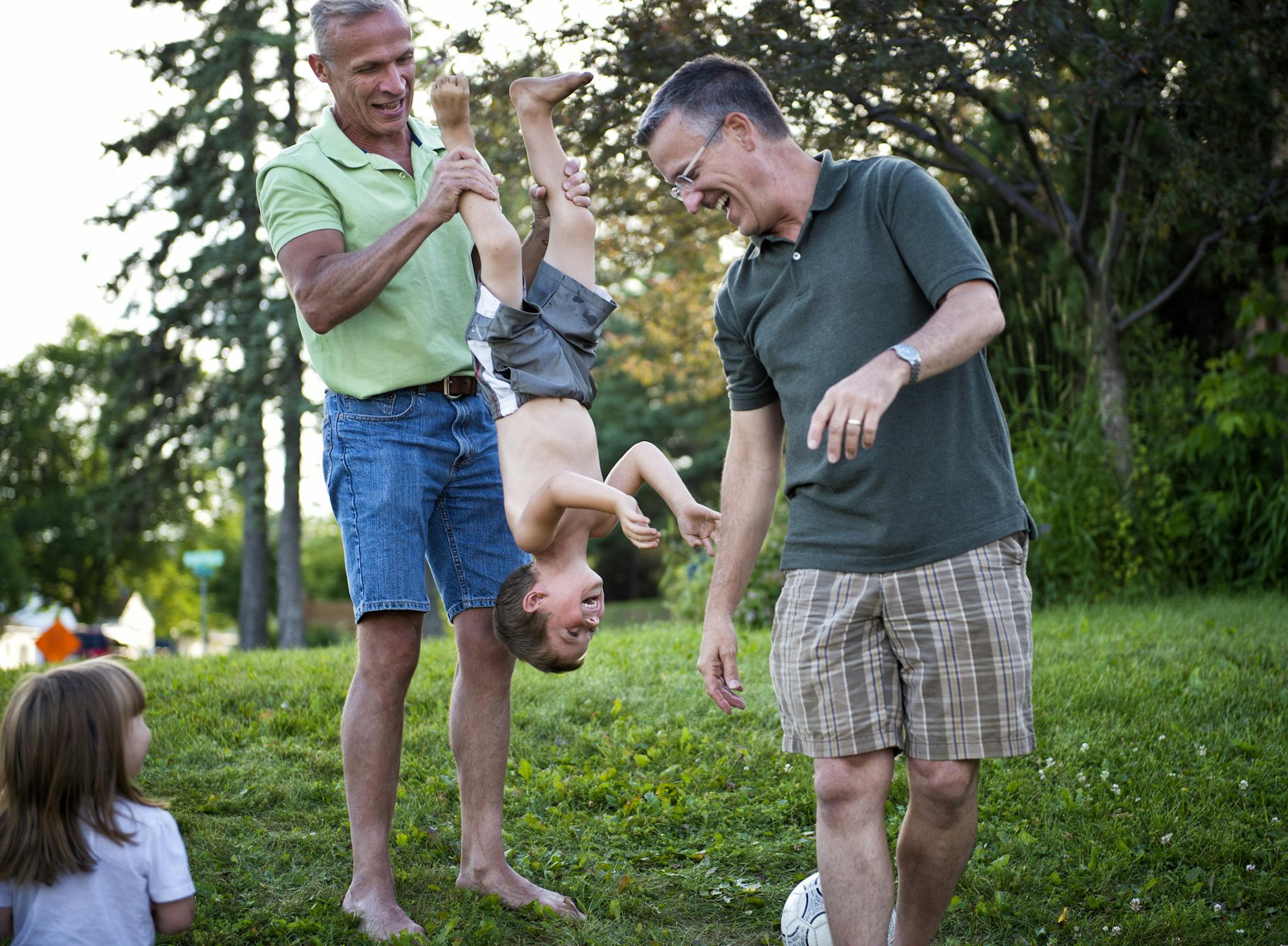 Gary and Tim played with son Sam, 5, during the softball game. After being in a committed relationship for 19 years, Tim Robinson and Gary Lundstrom will be getting married in Duluth. They cheered at a softball game for one of the girls that call them daddy in their family. One of the girls calls it their "most perfect imperfect family" Wednesday, July 24, 2013. ] GLEN STUBBE * gstubbe@startribune.com EDS, Gary is wearing light green shirt, Tim is in a dark green shirt and wears glasses. Kiana a