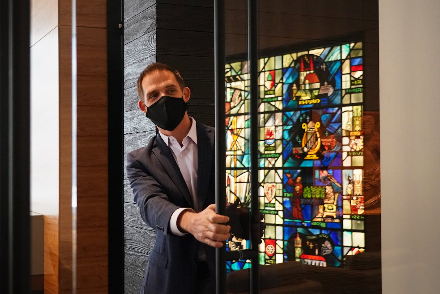 Eric Merriman, director of real estate, held open the door to the executive suite where a reflection of The Reformation Window shone on the glass door. ] Shari L. Gross ¥ shari.gross@startribune.com Thrivent unveiled its new $125 million headquarters building in downtown Minneapolis.