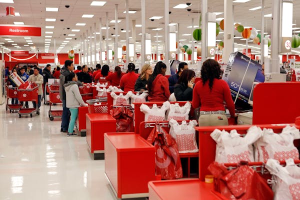 Customers purchase merchandise at a Target Corp. store in Chicago.