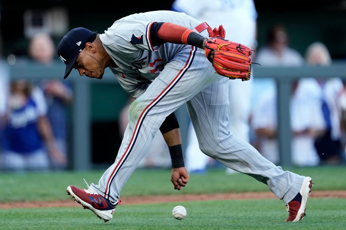 Minnesota Twins third baseman Jorge Polanco misses the ball as he tries to field a bunt single hit by Kansas City Royals' Kyle Isbel during the second inning of a baseball game Saturday, July 29, 2023, in Kansas City, Mo. (AP Photo/Charlie Riedel)