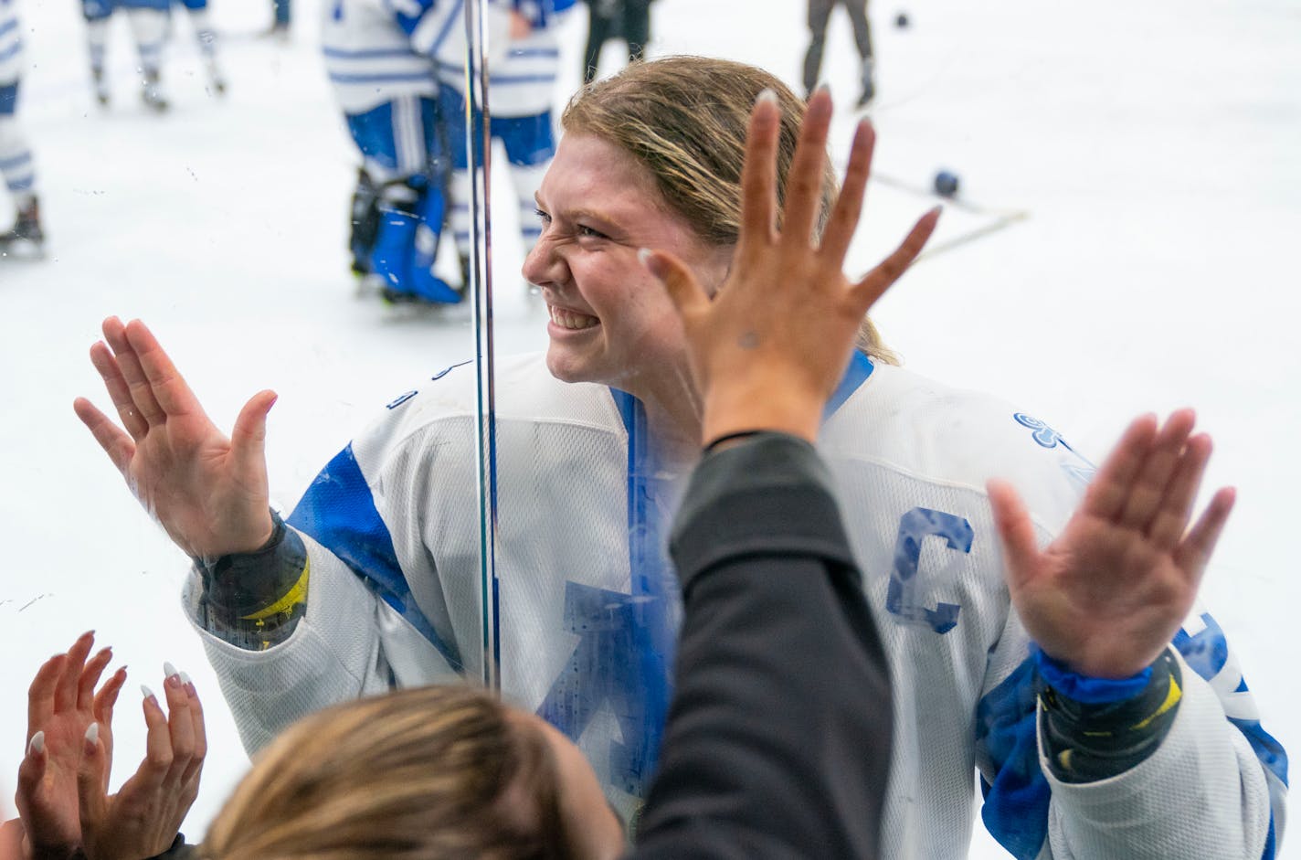 Minnetonka defender Elly Klepinger (22) celebrates on the glass near the student section after defeating Holy Family 4-0 in the Class 2A Section 2 girl's hockey Championship Friday, Feb. 17, 2023 at Braemar Arena in Edina, Minn. ]