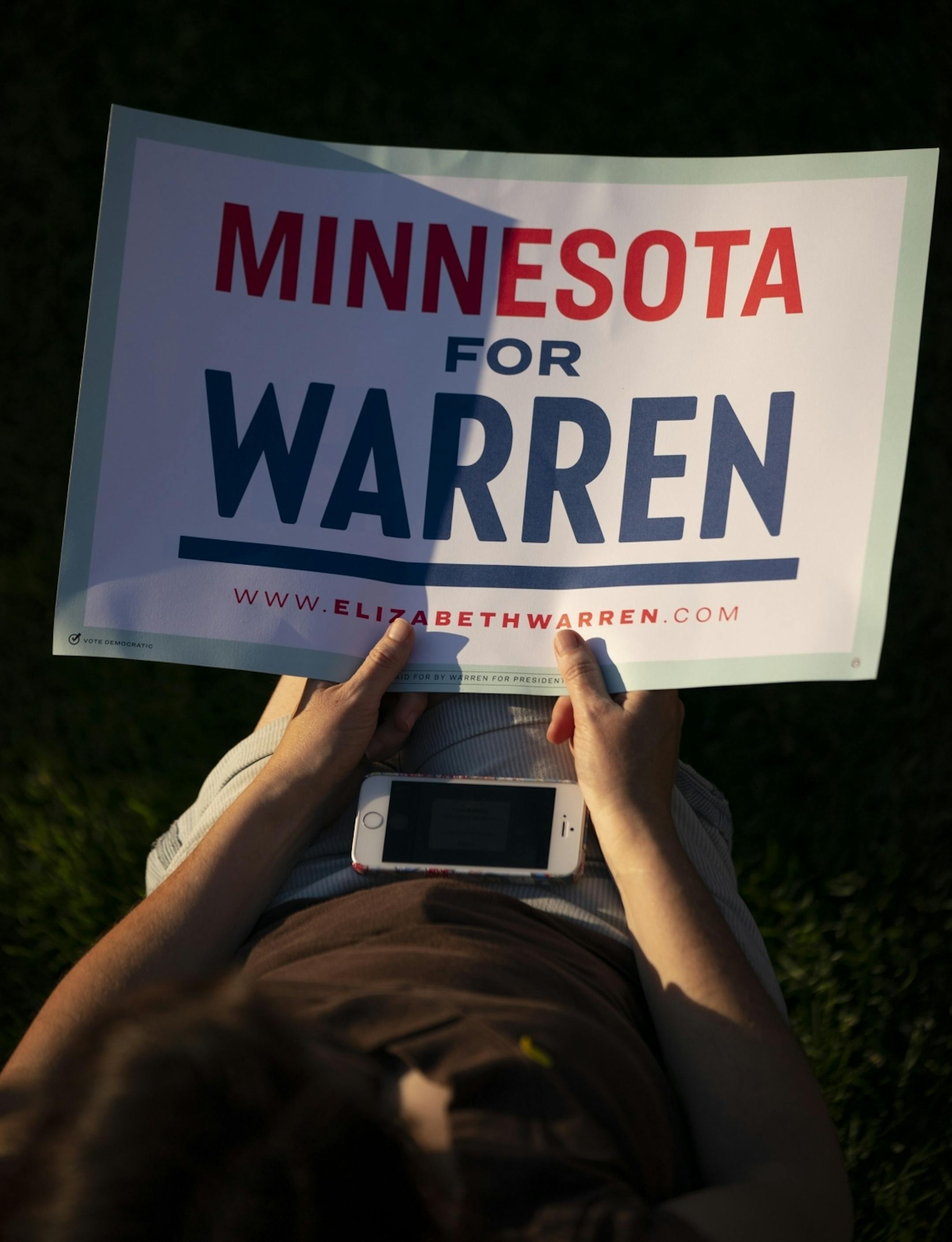 A Warren supporter held a sign in her lap while she listened to her candidate.