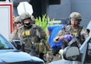 FBI, Orlando Police Department and the Orange County Sheriff's Office personnel investigate the attack at the Pulse nightclub in Orlando Fla., Sunday,