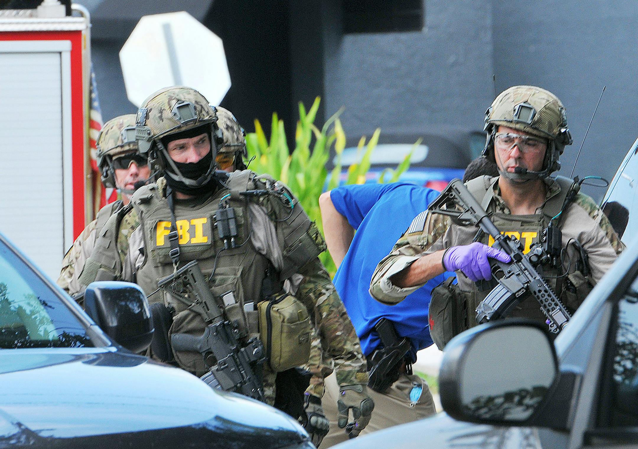 FBI, Orlando Police Department and the Orange County Sheriff's Office personnel investigate the attack at the Pulse nightclub in Orlando Fla., Sunday, June 12, 2016. A gunman wielding an assault-type rifle and a handgun opened fire inside a crowded gay nightclub in Orlando, Fla.,early Sunday, before dying in a gunfight with SWAT officers, police said. It was the worst mass shooting in American history. (Craig Rubadoux/Florida Today via AP) NO SALES; MANDATORY CREDIT ORG XMIT: MIN2016061217163405