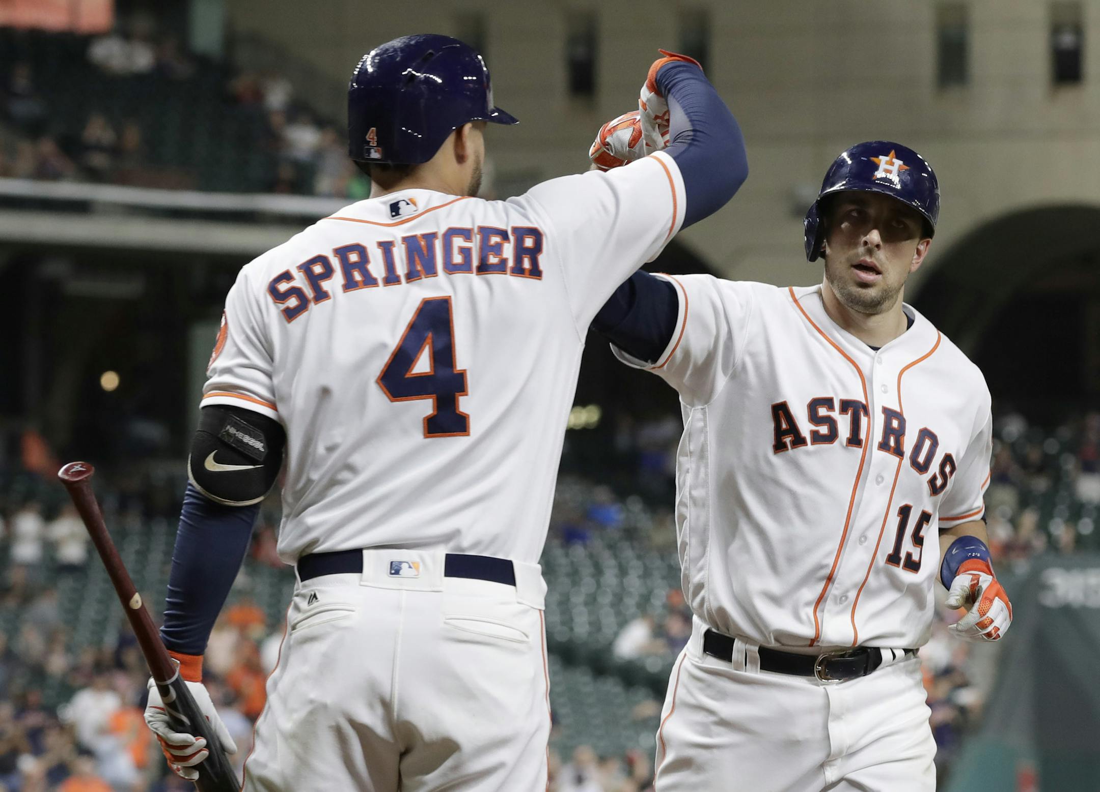 Houston Astros' Jason Castro (15) is congratulated by George Springer (4) after hitting a home run against the Texas Rangers during the sixth inning of a baseball game Tuesday, Sept. 13, 2016, in Houston. (AP Photo/David J. Phillip) ORG XMIT: TXDP115