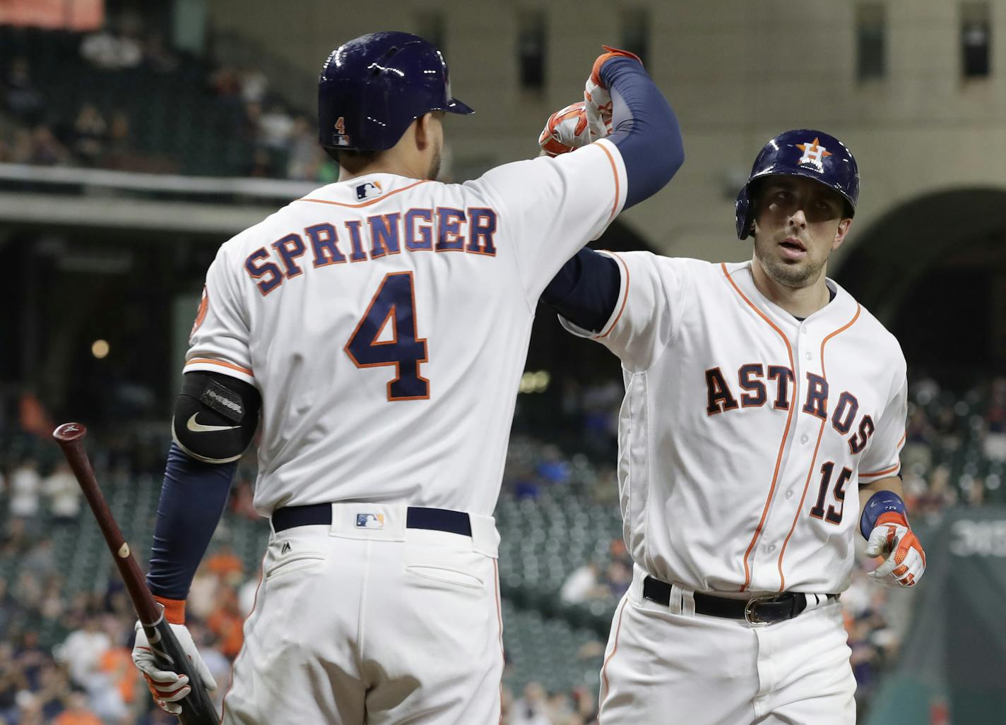 Houston Astros' Jason Castro (15) is congratulated by George Springer (4) after hitting a home run against the Texas Rangers during the sixth inning of a baseball game Tuesday, Sept. 13, 2016, in Houston. (AP Photo/David J. Phillip) ORG XMIT: TXDP115