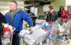 t1.15 Janna Goerdt -- goerdtZUPS01015c1 -- Gene Palm waits in a long line of shoppers at the Zup's Food Market in Aurora on Monday. Local shoppers are