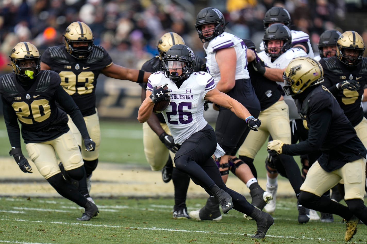 Northwestern running back Evan Hull (26) runs against Purdue during the first half of an NCAA college football game in West Lafayette, Ind., Saturday, Nov. 19, 2022. (AP Photo/Michael Conroy)