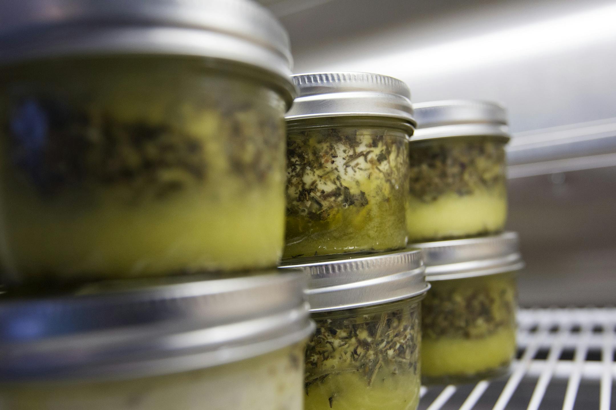 Singing Hills Goat Dairy of Nerstrand sells Marinated Herbed Chèvre by the jar from an on-site refrigerator at the Mill City Farmers Market June 7, 2014. (Courtney Perry/Special to the Star Tribune)
