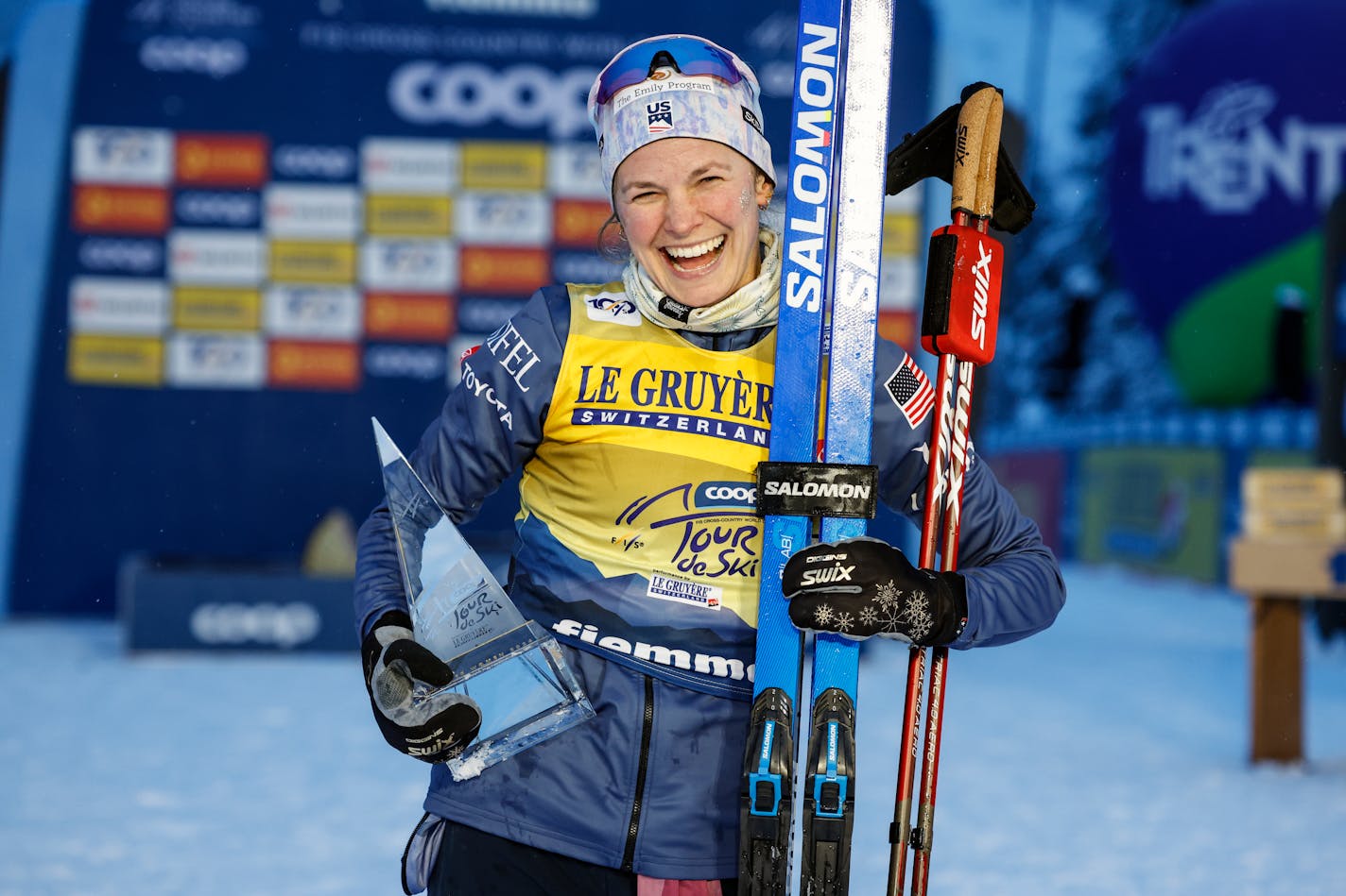 United States's Jessie Diggins poses with the trophy after winning the cross-country ski, women's Tour de Ski overall standings, in Val di Fiemme, Italy, Sunday, Jan. 7, 2024. (AP Photo/Alessandro Trovati)