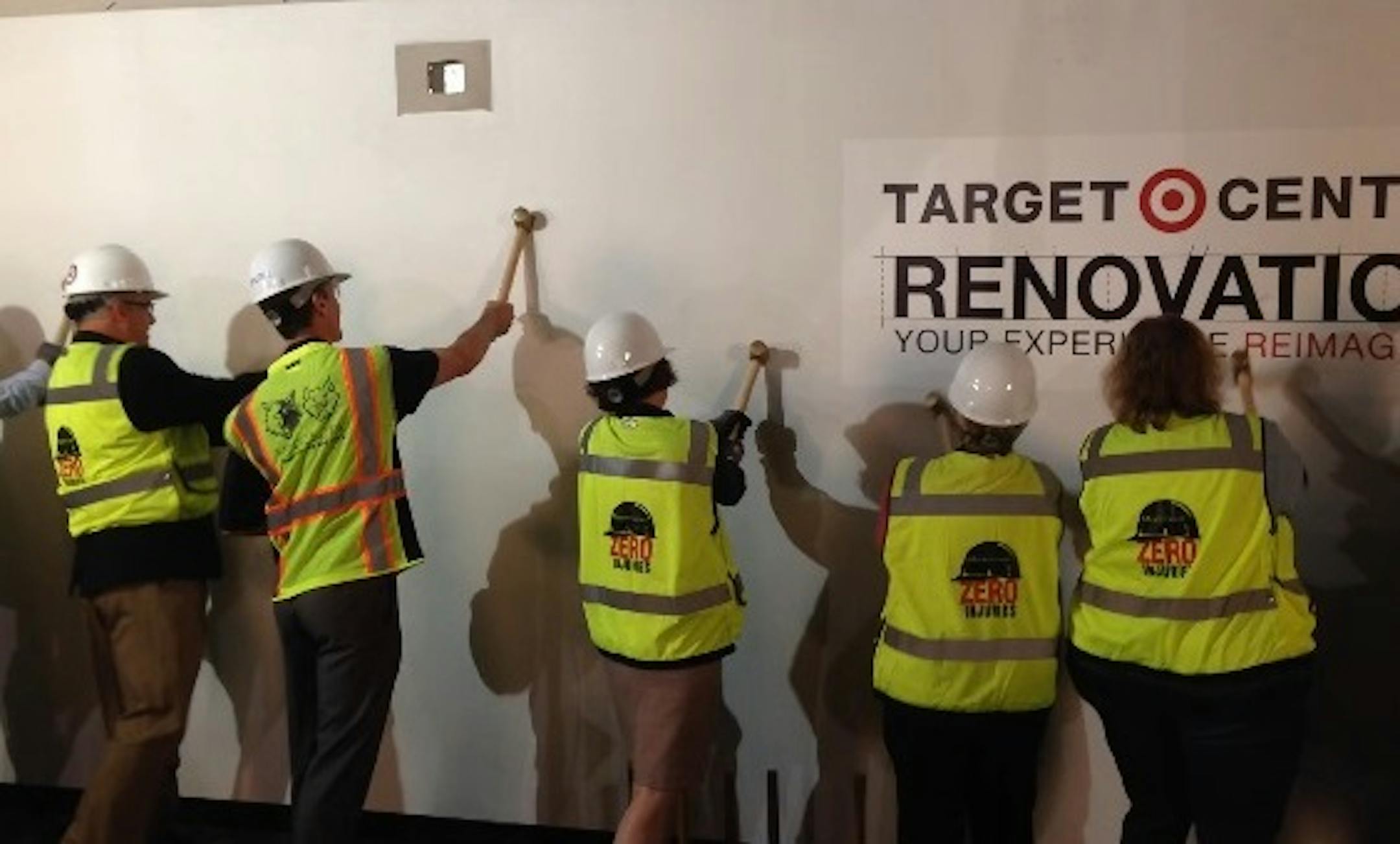 Officials, including Minneapolis Mayor Betsy Hodges (middle), used golden sledgehammers as part of a ceremonial start of Target Center renovations Wednesday. Photo/Michael Rand