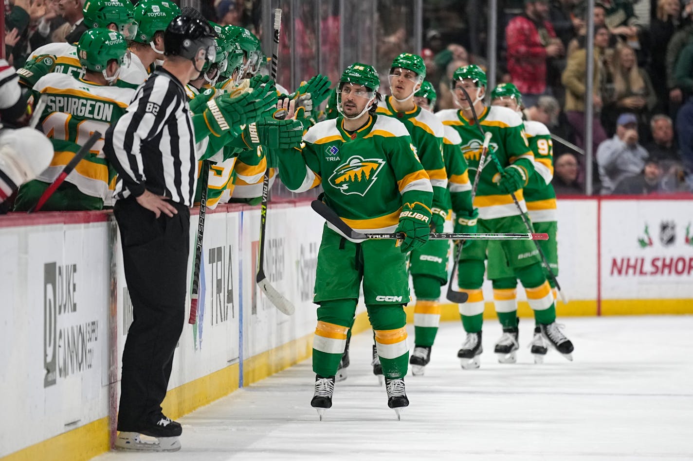 Minnesota Wild right wing Mats Zuccarello (36), front right, celebrates with teammates after scoring the Wild's third goal against the Chicago Blackhawks during the second period of an NHL hockey game Friday, Dec. 16, 2022, in St. Paul, Minn. (AP Photo/Abbie Parr)