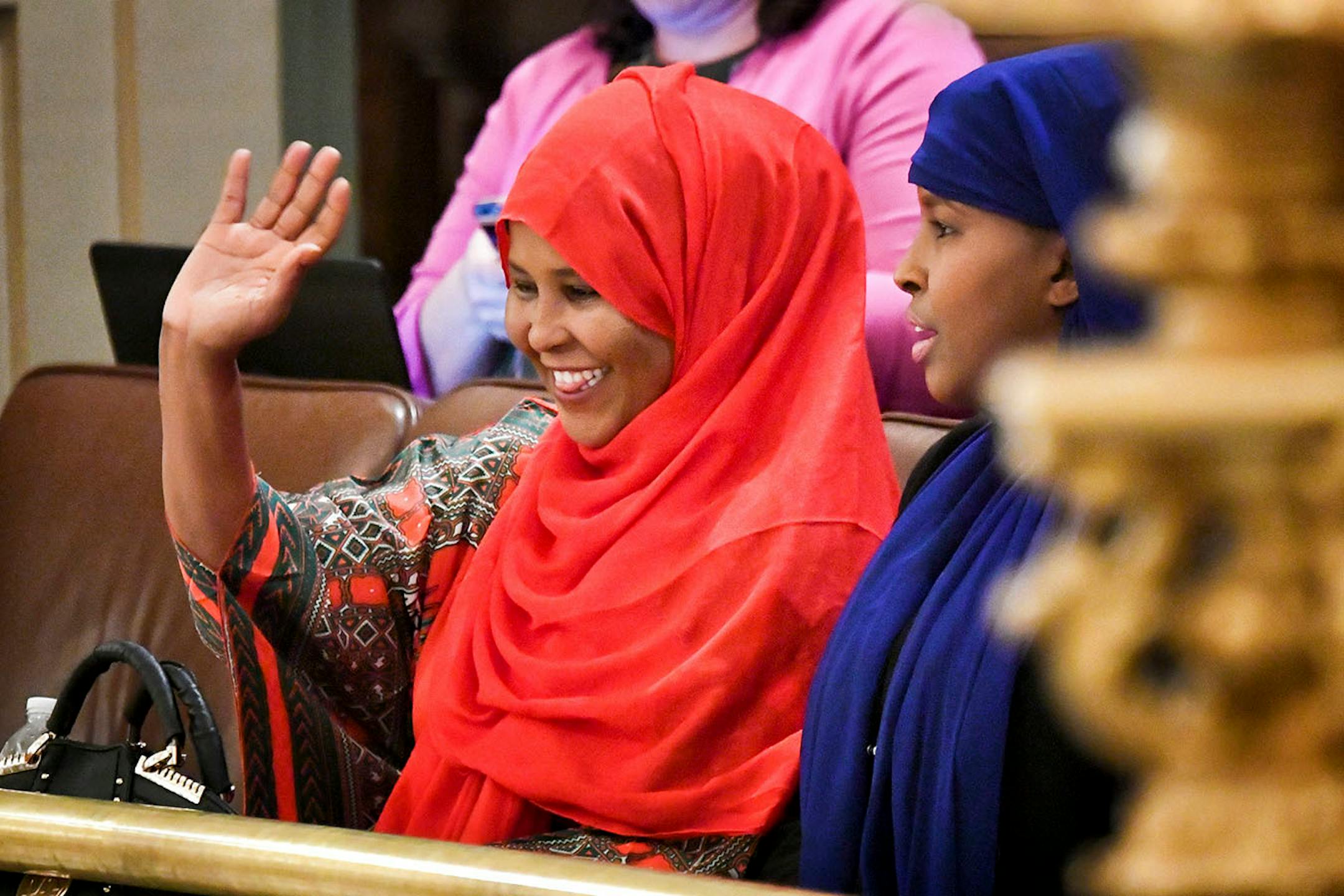 Genital mutilation survivors Farhio Khalif and Fadumo Abdinur waved to Representative Mary Franson, R-Alexandria, as she spoke on the House floor on her bill that would hold Minnesota parents liable for the practice of female genital mutilation.