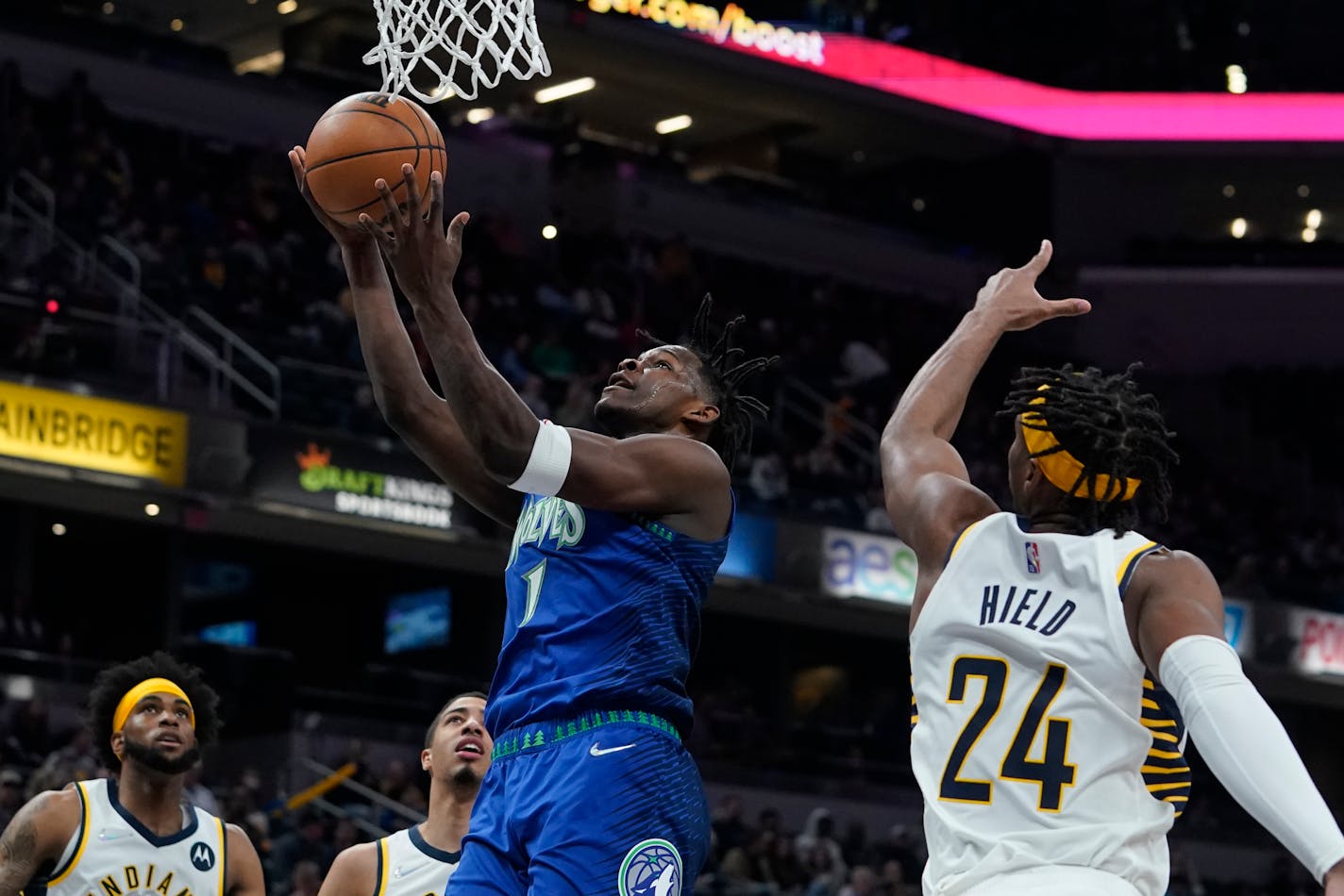 Minnesota Timberwolves' Anthony Edwards (1) shoots against Indiana Pacers' Buddy Hield (24) during the first half of an NBA basketball game, Sunday, Feb. 13, 2022, in Indianapolis. (AP Photo/Darron Cummings)