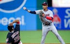 Minnesota Twins' Jorge Polanco forces out Cleveland Indians' Austin Jackson at second base and throws out Jose Ramirez at first base to complete the d