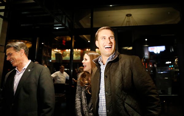 Kirk Cousins and his wife Julie Hampton exit dinner at Capital Grille in Minneapolis with Vikings General Manager Rick Spielman on Wednesday night.