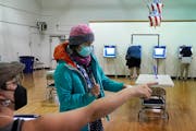Monica Rojas gets directions from a poll worker on her way to casting her ballot at Sabathani Community Center during municipal elections Tuesday, Nov