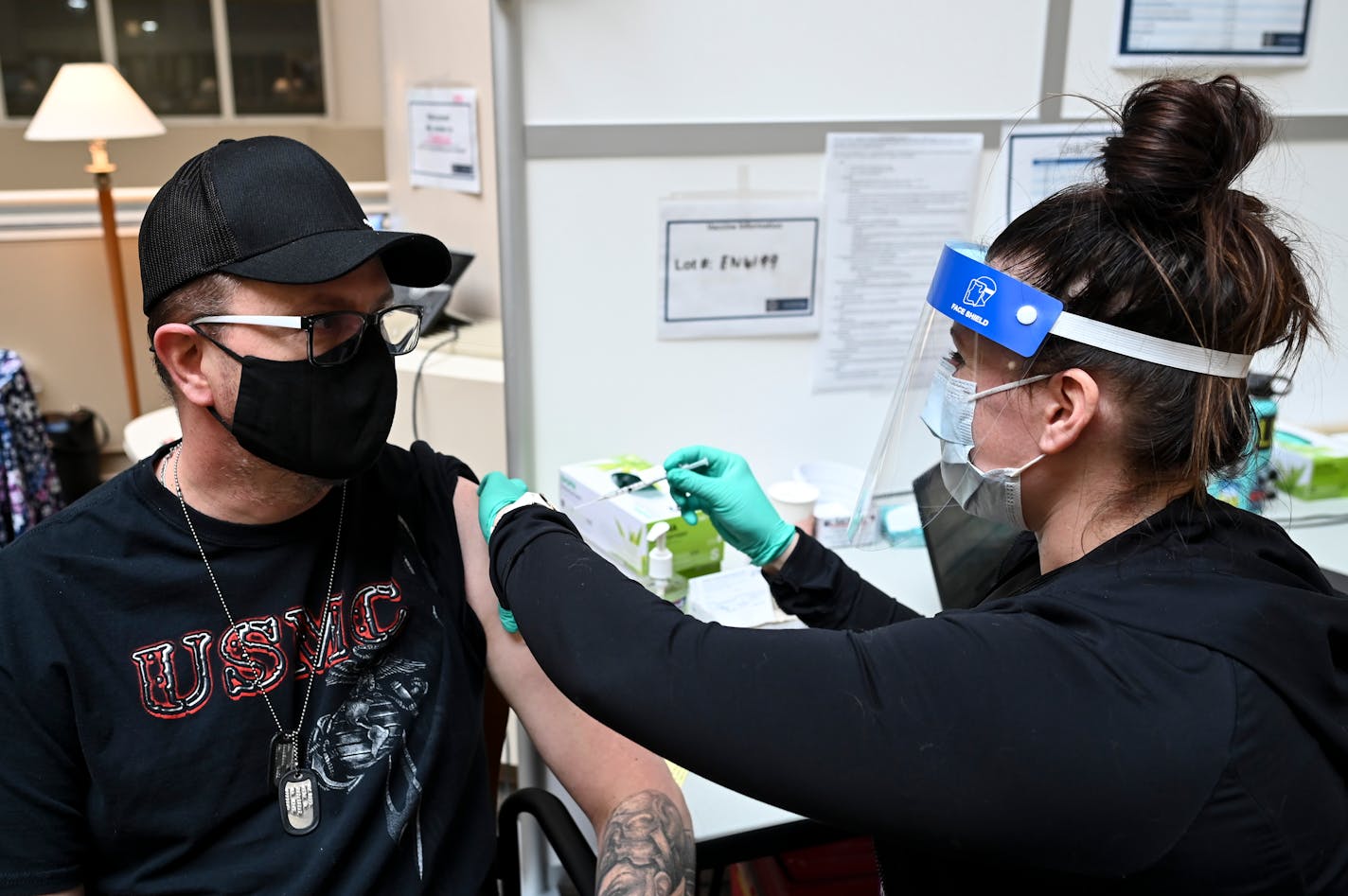 James Allison, 49, an eight year veteran with the United States Marine Corp., received a dose of the Pfizer-BioNTech COVID-19 vaccine Tuesday at the Minneapolis VA. Allison received a text late last week alerting him that he was eligible to receive the vaccine while he was driving back from visiting his 20-year old daughter, who is serving in the Navy in Virginia. ] AARON LAVINSKY • aaron.lavinsky@startribune.com