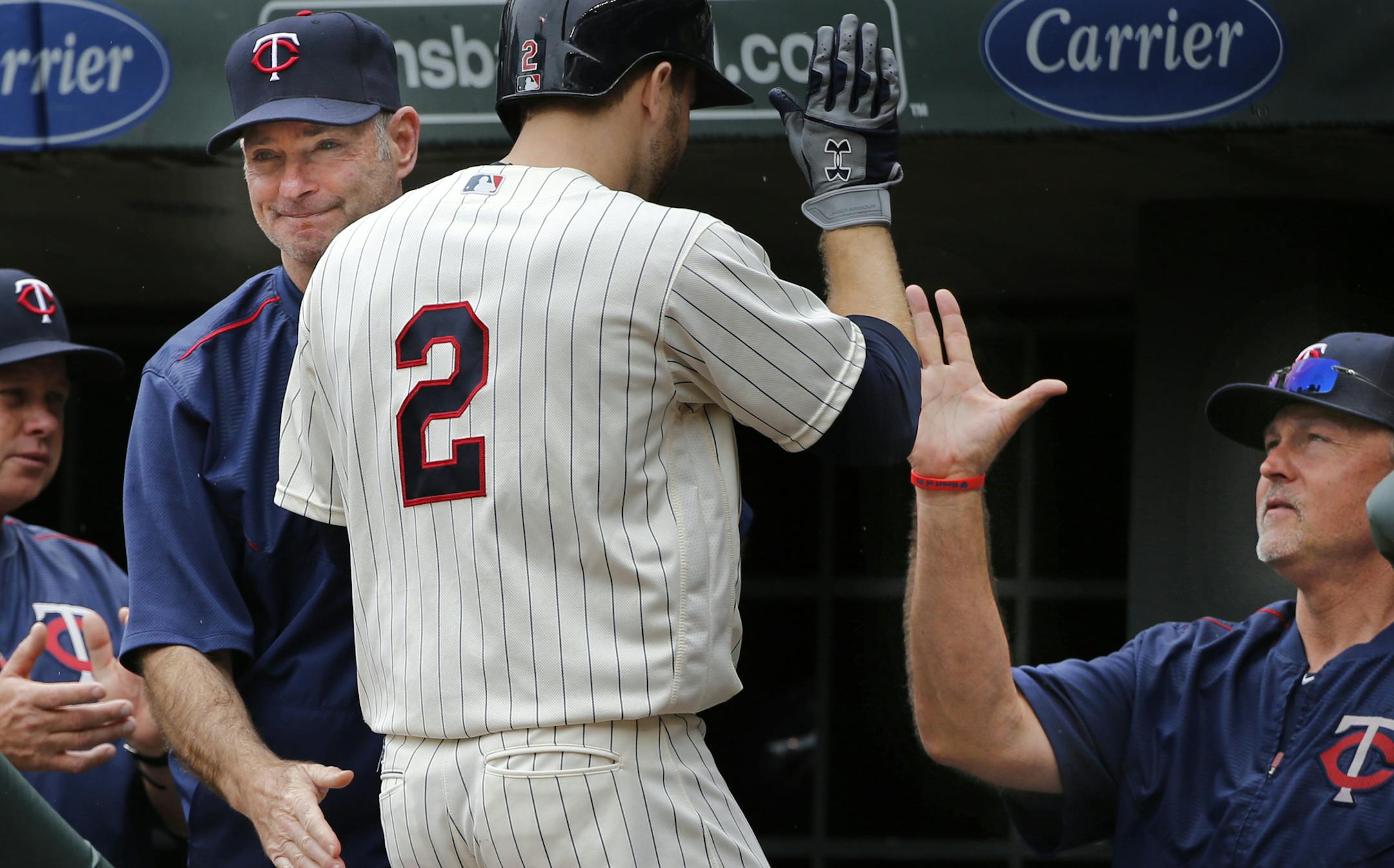 Brian Dozier(2) rounds the bases after he homers in the first inning and is greeted by manager Paul Molitor,left, and hitting coach Tom Brunansky, on the right.]At the Twins game against Kansas City on 5/25/16 at Target Center.Richard Tsong-Taatarii/rtsong-taatarii@startribune.com