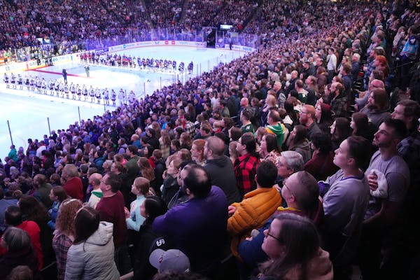 Fans stand for the National Anthem ahead of the first home game of the brand new women's professional hockey league (PWHL) as Minnesota faced off agai