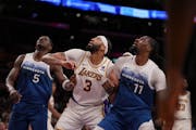 Anthony Davis, center, ate up the Wolves the last time the teams met, on March 10, with 27 points and 25 rebounds.