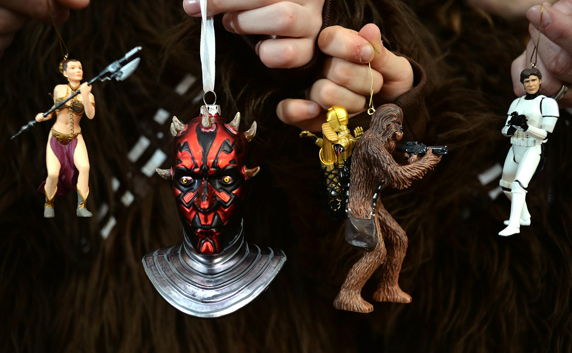The Novak's family tree, which proudly stands in the front window of their Maple Grove home, is fully decorated with nothing by Star Wars ornaments. Here they each display their favorite piece of the Christmas tradition. ] (SPECIAL TO THE STAR TRIBUNE/BRE McGEE) **Novak family