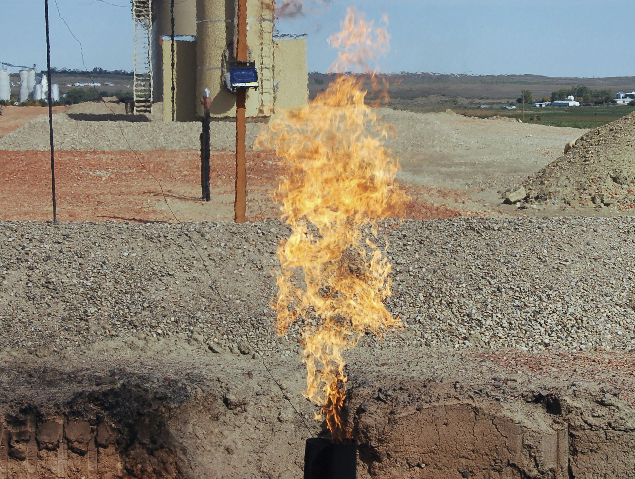 FILE - In this Sept. 23, 2008 file photo, natural gas is flared from an oil well near Parshall, N.D. The North Dakota Industrial Commission is holding a hearing in Bismarck on Tuesday, April 22, 2014, on its new natural gas flaring policy that's intended to cut back on the amount of natural gas burned off and wasted as a byproduct of natural gas production. The percentage of gas being flared in the state is pegged at a record 36 percent. (AP Photo/James MacPherson, File) ORG XMIT: MIN20140422141