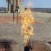 FILE - In this Sept. 23, 2008 file photo, natural gas is flared from an oil well near Parshall, N.D. The North Dakota Industrial Commission is holding