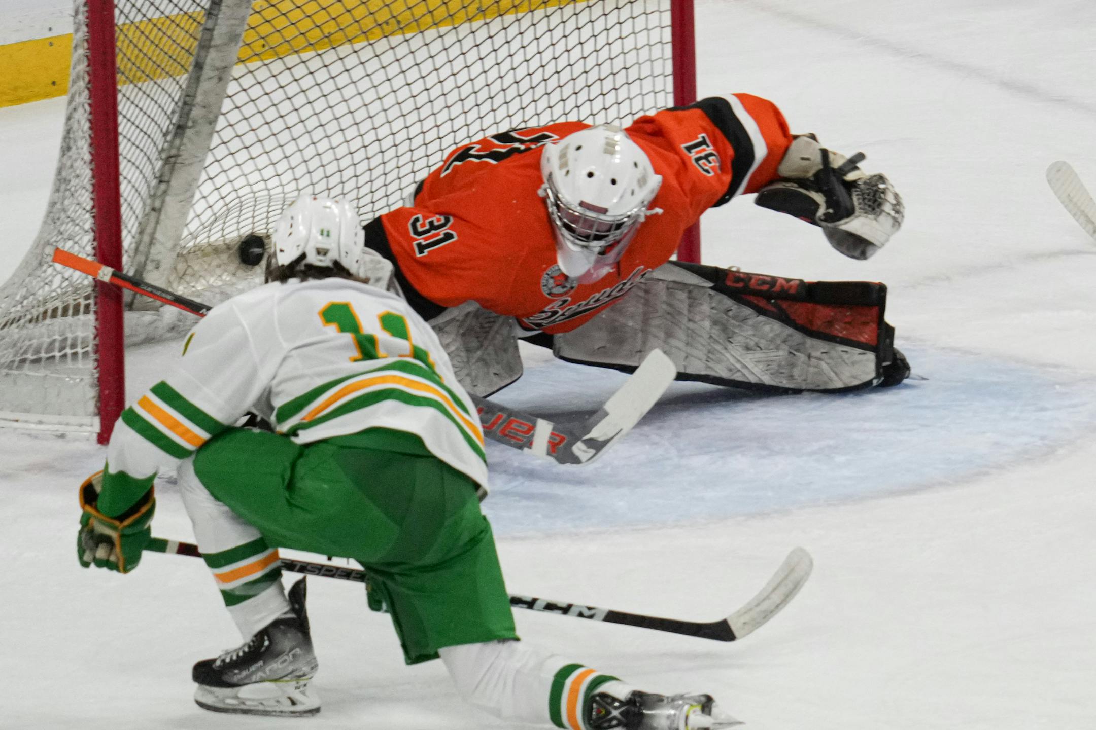 Edina forward Ryan Flaherty (11) scores a goal against Moorhead goaltender Kai Weigel (31) in the first period.