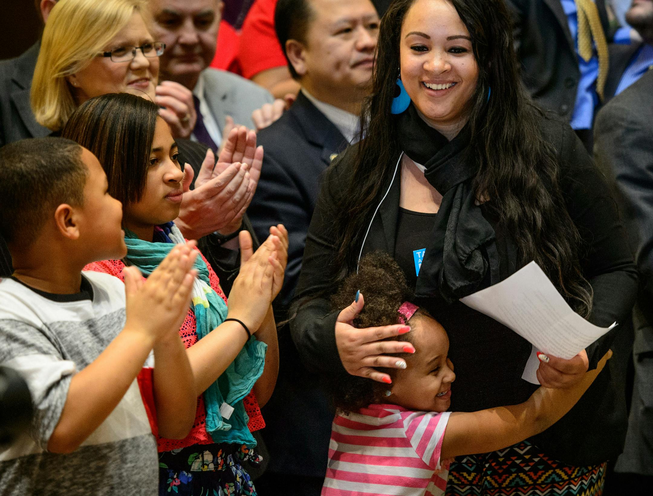 Jacquita Berens got a hug from her daughter Ashia Rhodes after speaking at the bill signing. She was there with her three children Jada and Mario. Jacquita Berens works three jobs and will benefit from the minimum wage increase. Governor Dayton signed the minimum wage bill into law at a public bill signing ceremony Monday the Minnesota State Capitol Rotunda. The bill, which was passed by the Legislature last week, will increase Minnesota’s minimum wage to $9.50 per hour, and index it to i