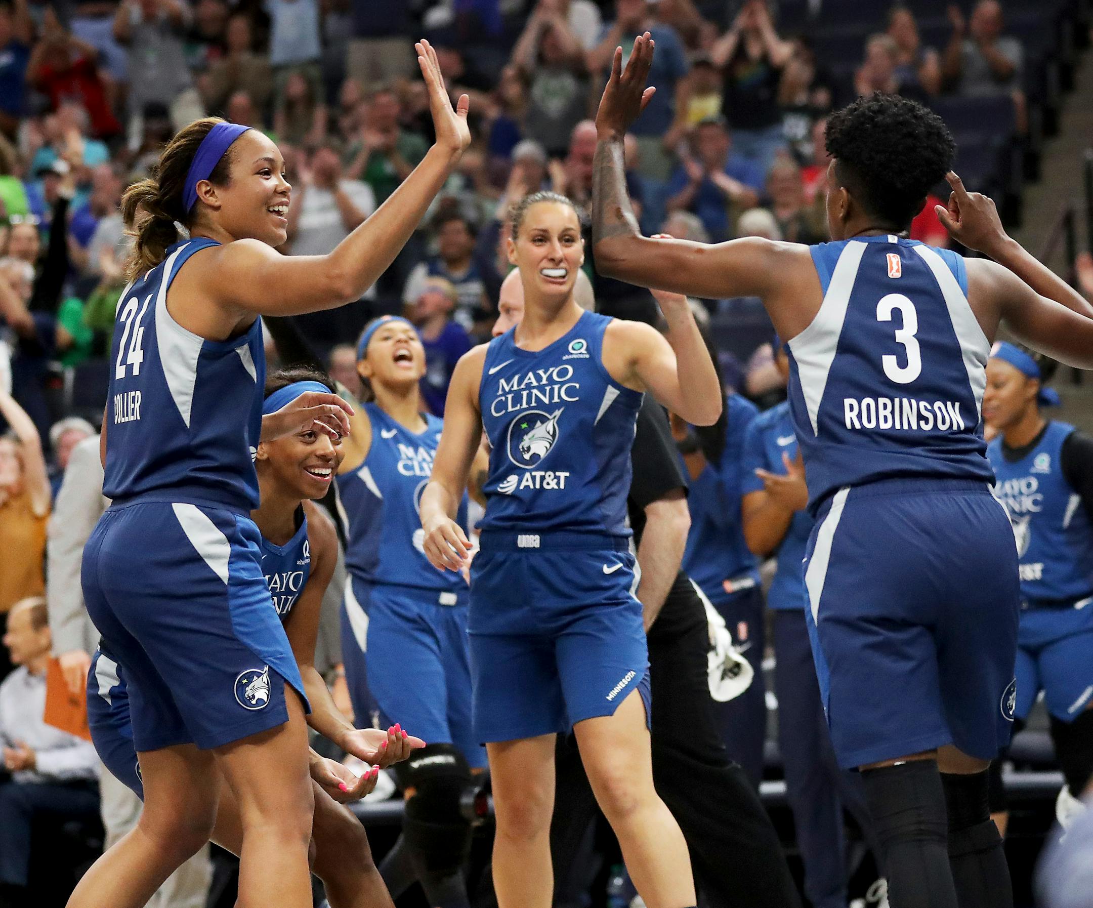 Danielle Robinson (3) celebrates her last-second basket to end the first quarter with teammate Napheesa Collier (24)